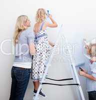 Young family paiting a room