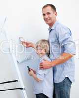 Father and his son painting a room
