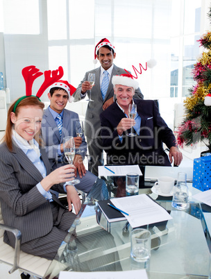 Manager and his team toasting with Champagne at a Christmas part