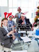 Manager and his team toasting with Champagne at a Christmas part