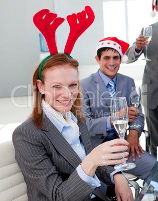 Portrait of a smiling businesswoman toasting with her colleagues