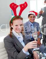 Portrait of a smiling businesswoman toasting with her colleagues