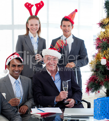 Smiling business people wearing novelty Christmas hat