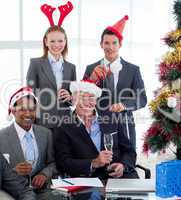 Smiling business people wearing novelty Christmas hat