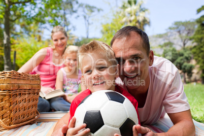 Smiling family ralaxing at a picnic