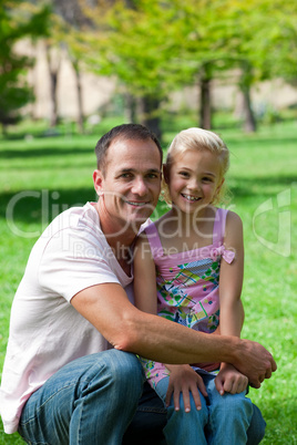 Smiling father and his daughter having a picnic