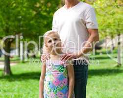 Cute little girl with her father in a park