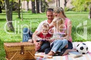 Young family relaxing while having a picnic