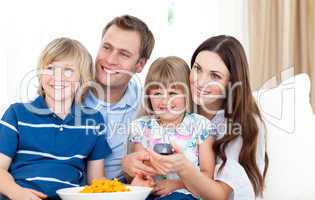 Smiling family watching TV