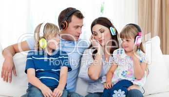 Family listening music with headphones