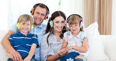 Smiling family listening music with headphones