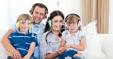 Smiling family listening music with headphones