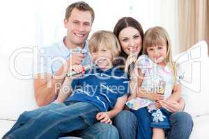 Smiling young family singing a karaoke together