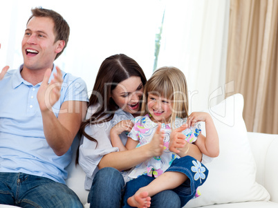 Happy family clapping a goal