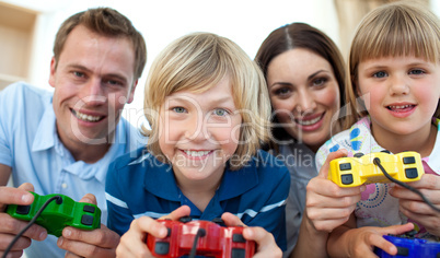 Smiling family playing video games together