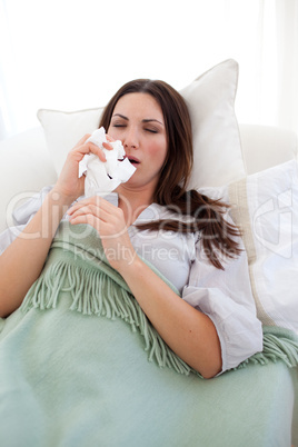Sick woman blowing lying on the sofa