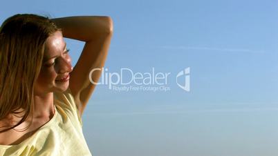 HD young woman smiling on a background of sky