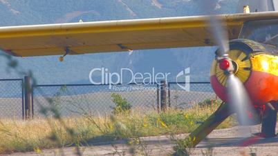 HD airplane with rotating propeller standing on concrete runway