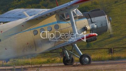 HD airplane with rotating propeller standing on concrete runway