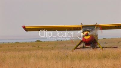 HD plane with propeller stands in middle of the field