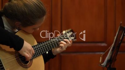 girl plays a guitar.