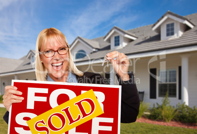 Beautiful Female Holding Keys & Sold Real Estate Sign