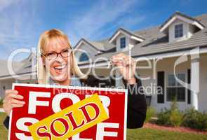 Beautiful Female Holding Keys & Sold Real Estate Sign