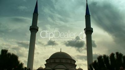 Time lapse clouds flowing past  twin minaret mosque 5