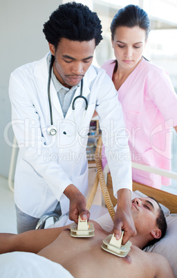 doctor using a defibrillator