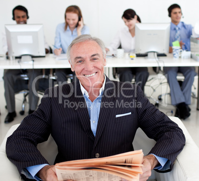 manager reading a newspaper