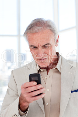 senior businessman sending a text