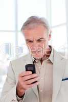 senior businessman sending a text