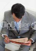 Ethnic businessman reading a newspaper