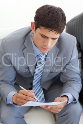 Concentrated businessman writing