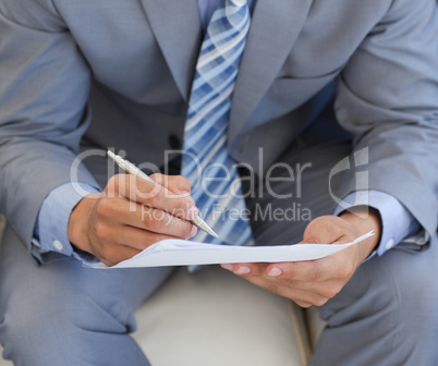 businessman writing on a paper