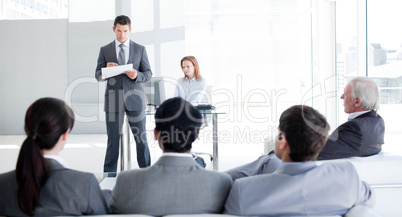 A teamleader talking to his colleagues
