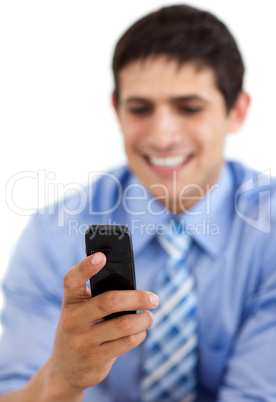 Smiling businessman sending a text