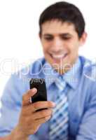 Smiling businessman sending a text