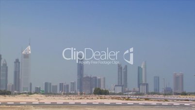 small car cross Dubai skyline pan burj emirates