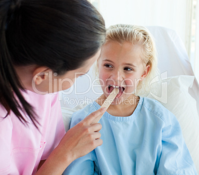 doctor examining a child's throat