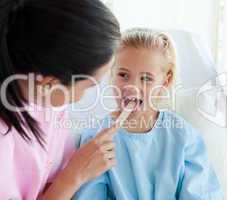 doctor examining a child's throat