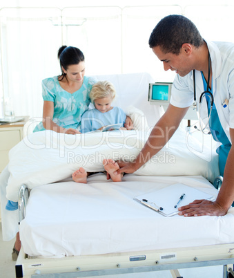 Young doctor examining a child patient