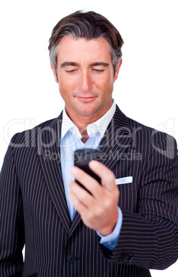 Serious businessman sending a text