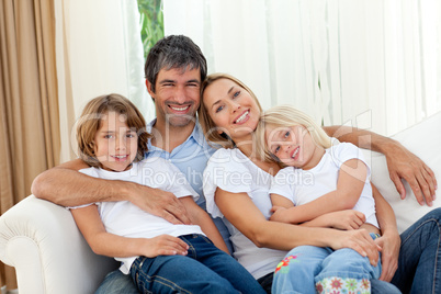 Smiling family relaxing on the sofa