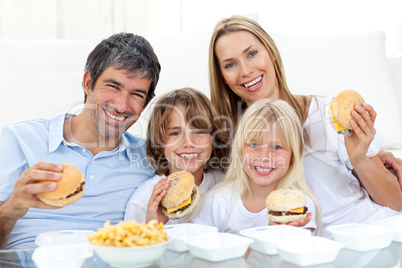 Happy family eating hamburgers