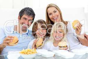 Happy family eating hamburgers