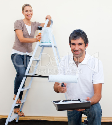 man and woman decorating a room