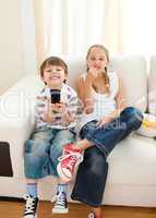Happy siblings watching TV