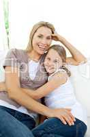 girl hugging her smiling mother