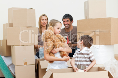 Family unpacking boxes after move in